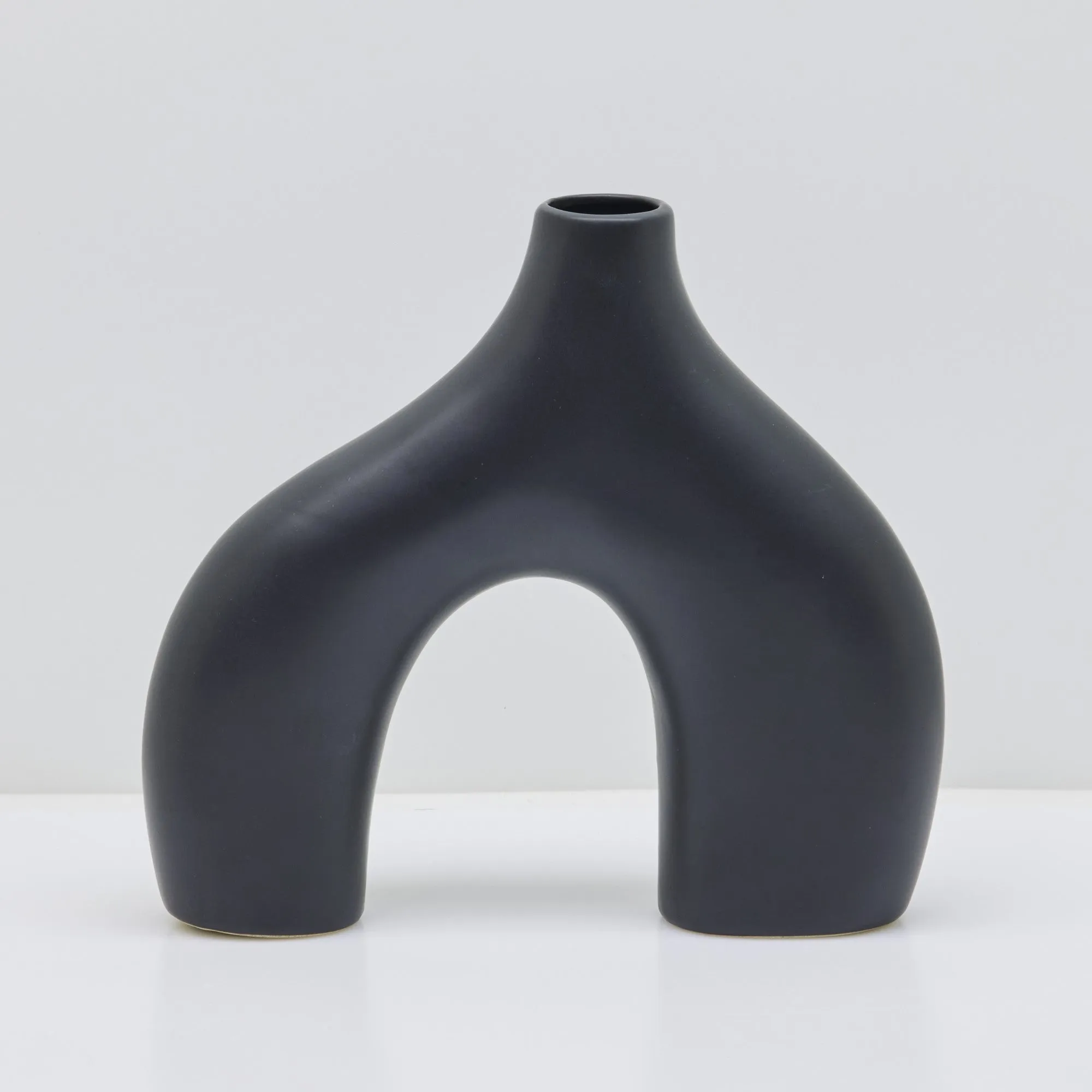 Sleek Black Stone Age-Inspired Arch Vase