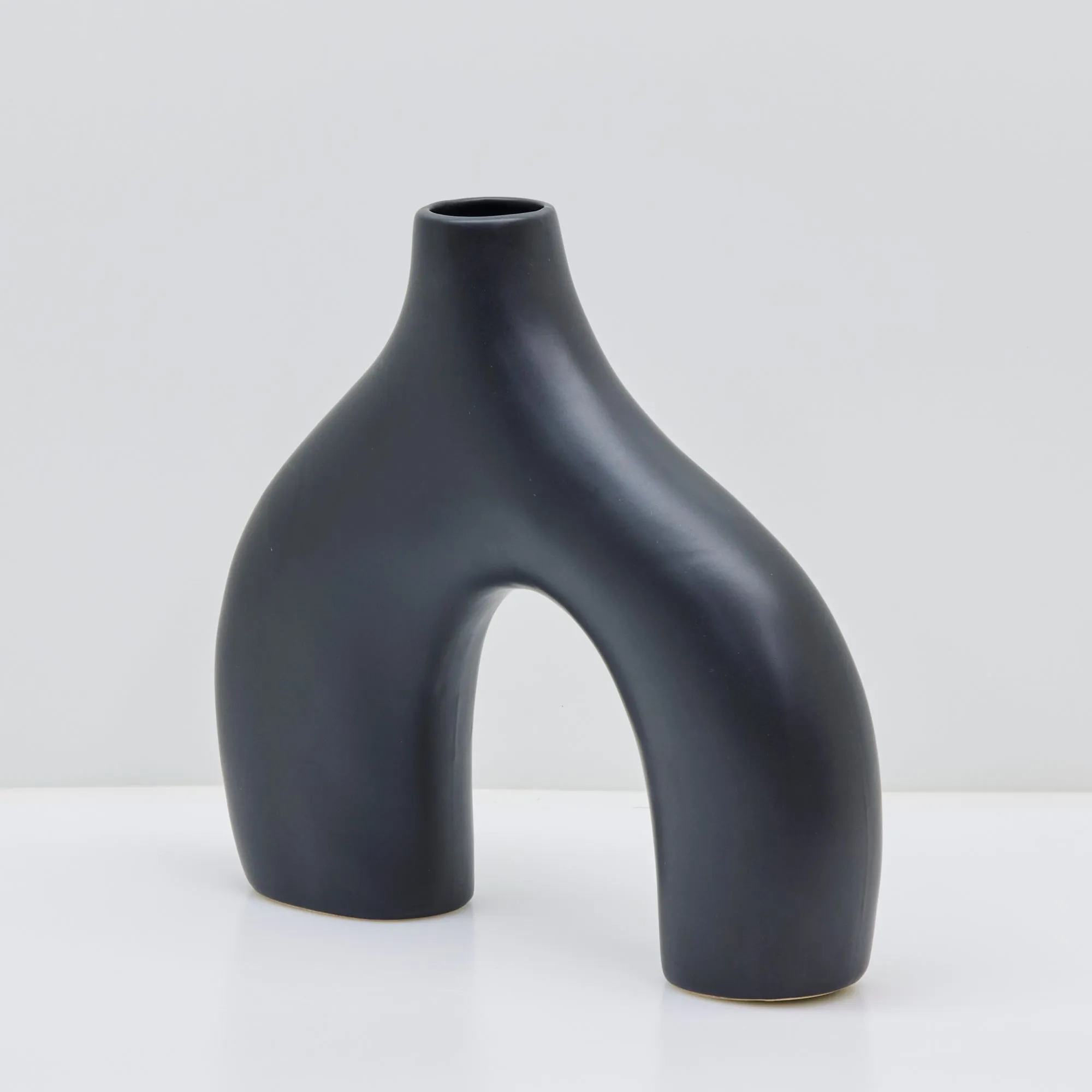 Sleek Black Stone Age-Inspired Arch Vase